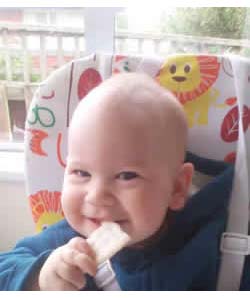 Happy Baby eating Rice Rusk